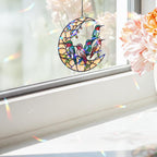 Moonlit hummingbird garden holographic acrylic suncatcher hanging outdoors with a soft green garden background