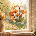 Poppy Lavender Fire and Bloom real stained glass suncatcher with orange flowers, lavender stems, golden crescent frame, and gold hanging chain