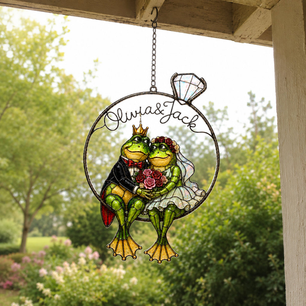 Personalized frog wedding suncatcher hanging on a covered porch
