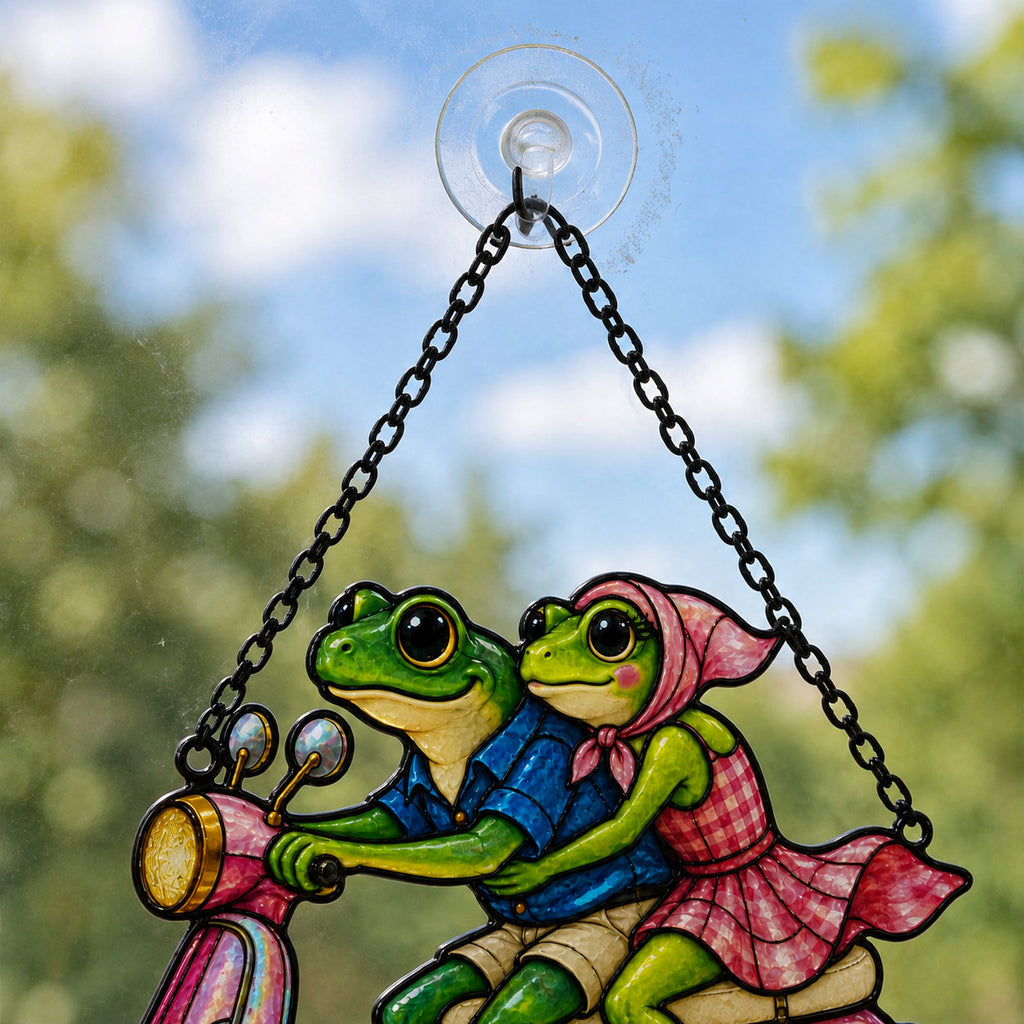 Close-up of the two frogs, headscarf and handlebars on the pink scooter suncatcher