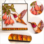 Detail image of the hummingbird fuchsia stained glass suncatcher showing the full design, close-up flower and bird sections, and the amber bottom border.