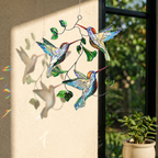 Hummingbird Leaf holographic acrylic suncatcher hanging on a sunlit wall, casting soft shadows and colorful rainbow reflections.
