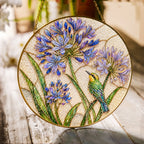 Agapanthus and bird stained glass suncatcher with gold frame on a white background