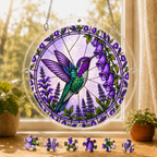 Round Amethyst Bellflower Hummingbird acrylic puzzle suncatcher hanging in a sunny window with loose colorful puzzle pieces displayed below.