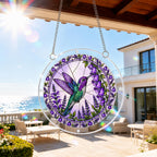 Purple hummingbird acrylic puzzle suncatcher hanging by a bright balcony window in natural sunlight.