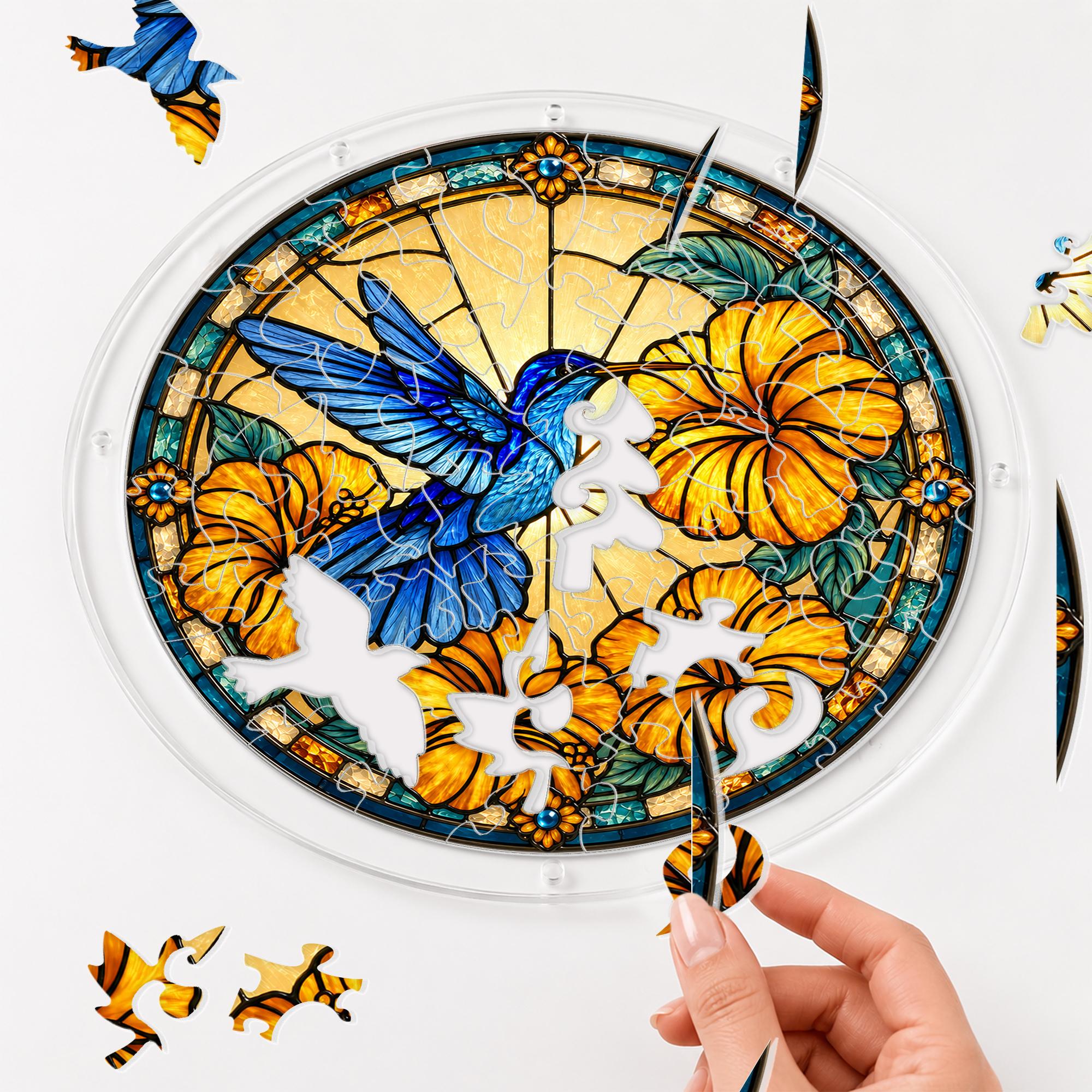 Hand placing a puzzle piece into the Azure Hibiscus Flight Hummingbird acrylic puzzle suncatcher.