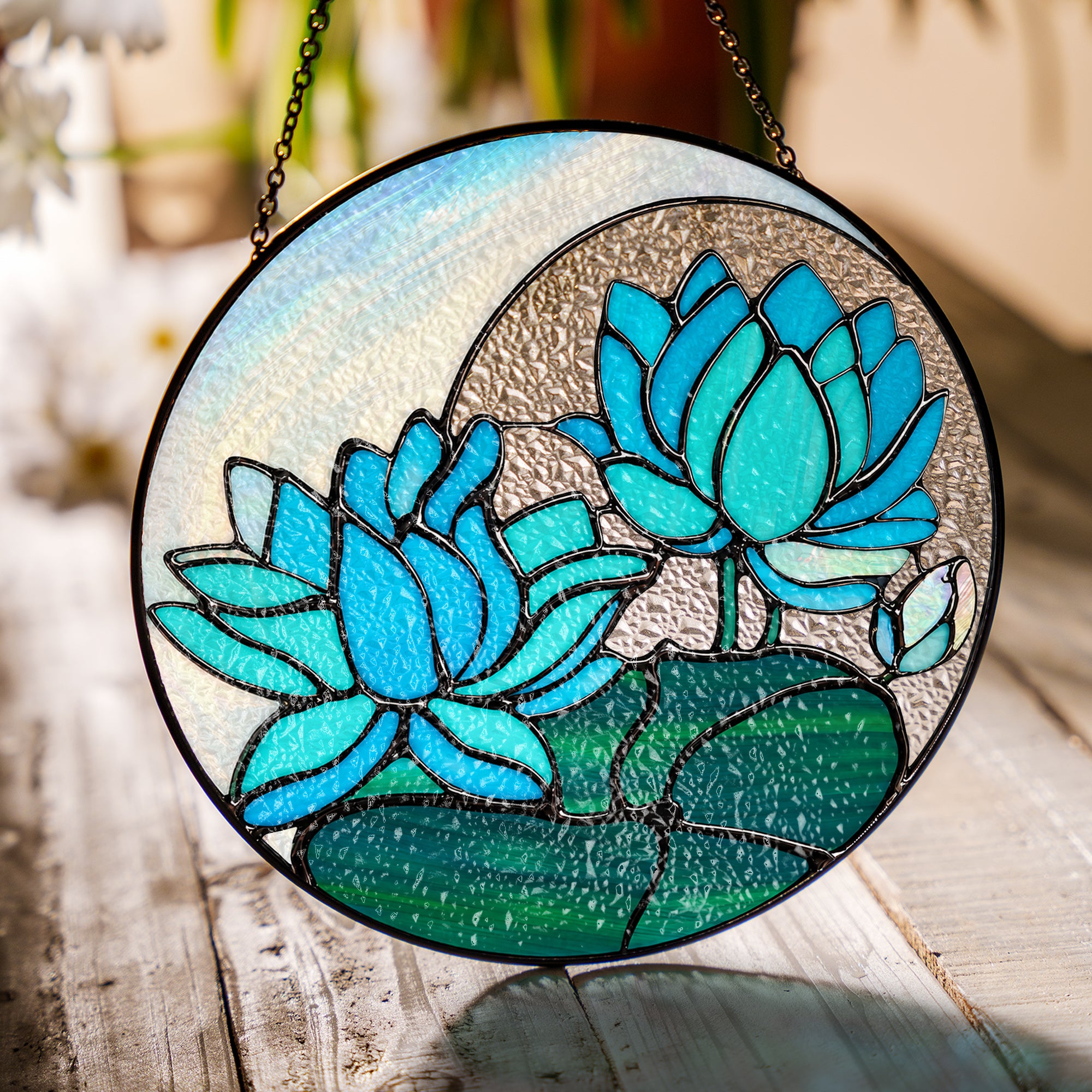 Blue lotus stained glass suncatcher in a bright window with soft daylight