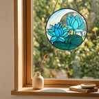 Blue lotus suncatcher in a cozy window with a small vase and soft natural light