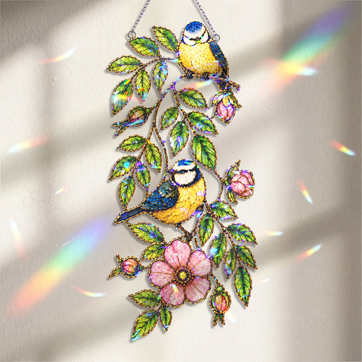 Blue tit and wild rose acrylic suncatcher hanging in a sunlit window as home decor