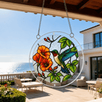 Blue wing hummingbird orange flower acrylic puzzle suncatcher displayed on a sunny patio