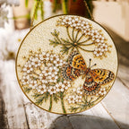 Butterfly and white flowers stained glass suncatcher with gold frame on a white background