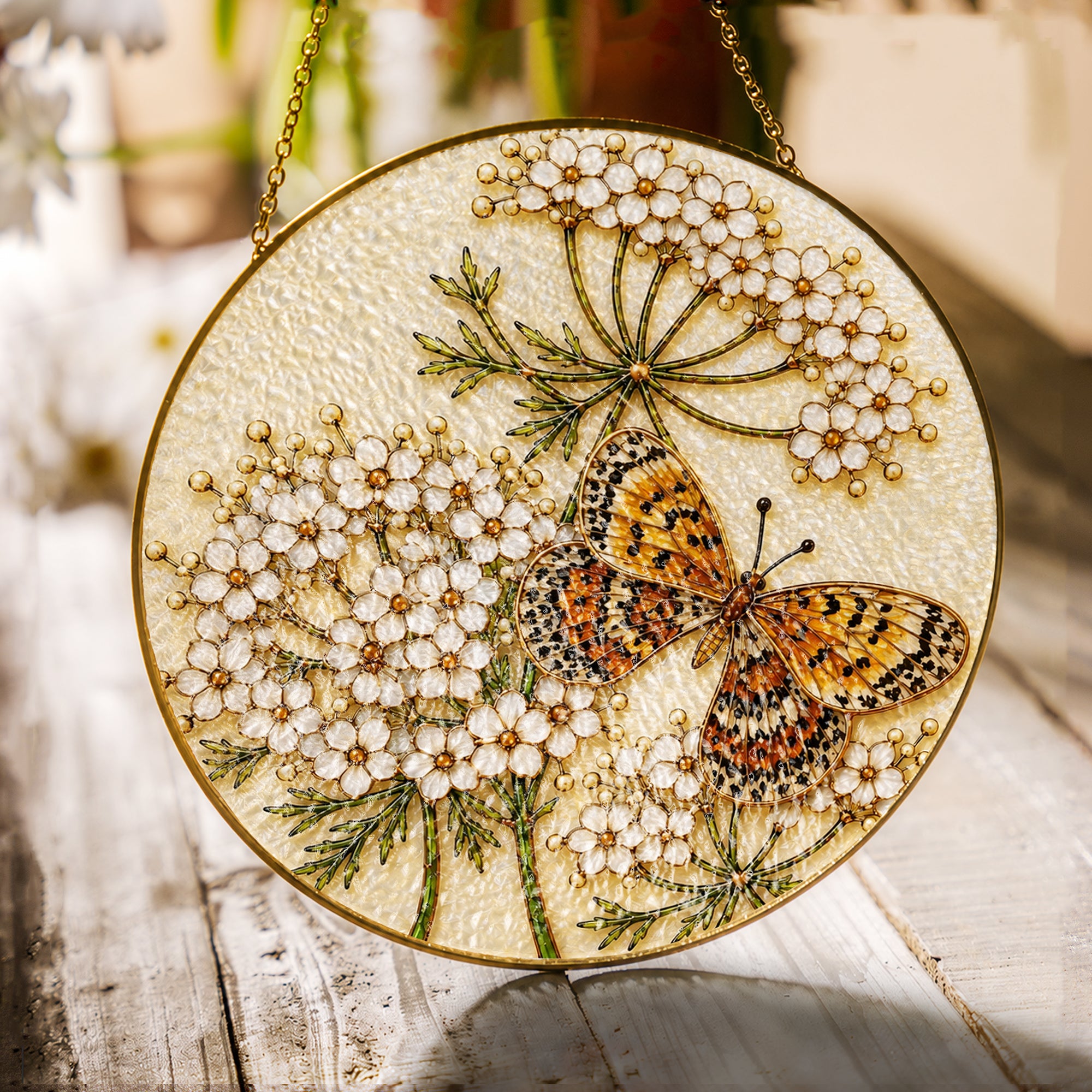 Butterfly and white flowers stained glass suncatcher with gold frame on a white background