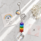 Personalized dog memorial moon crystal suncatcher displayed on marble surface with Rainbow Bridge sympathy card and soft white flowers