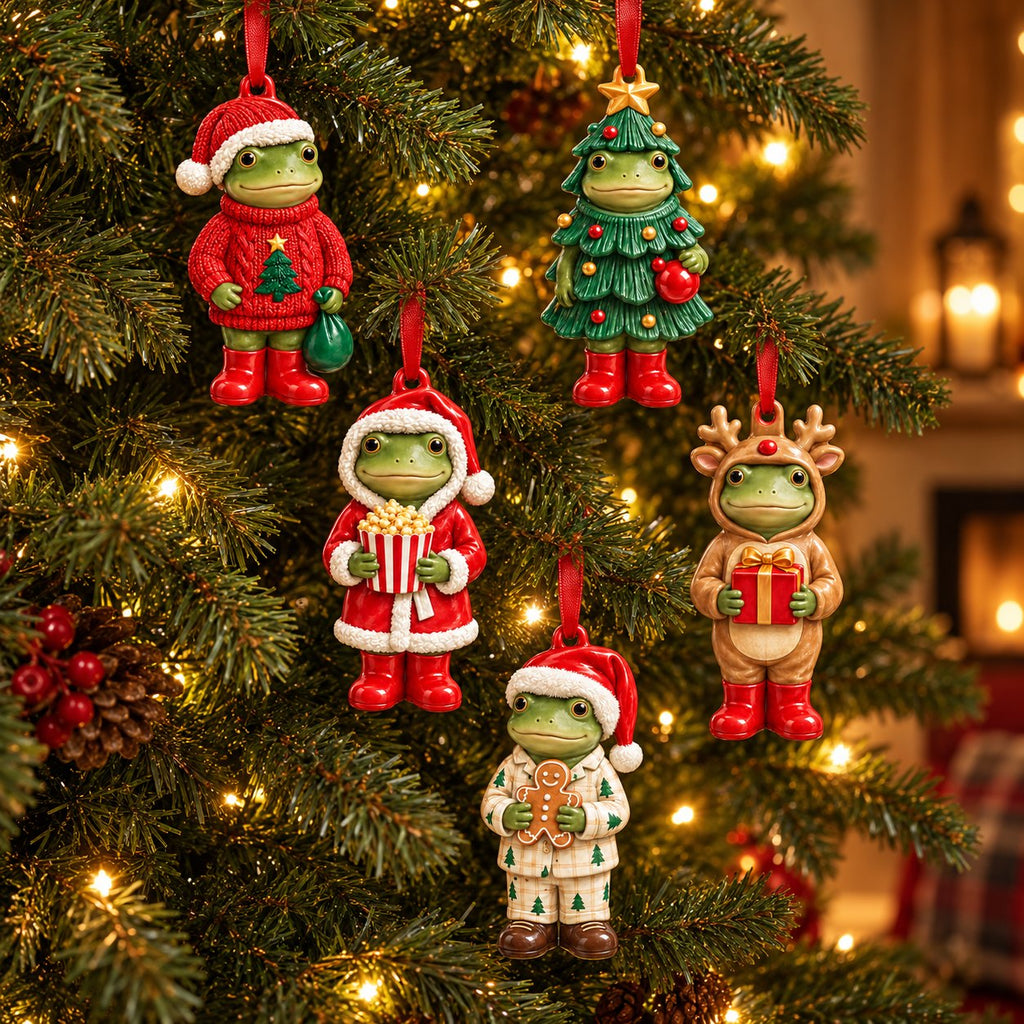 All five frog Christmas ornaments hanging on a Christmas tree by red ribbons