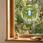 Citrine hummingbird acrylic puzzle suncatcher displayed in a cozy wooden window corner with soft daylight.