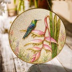 Hummingbird and pink heliconia stained glass suncatcher with gold frame on a white background