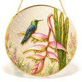 Hummingbird heliconia gold frame suncatcher in a sunny window