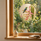 Hummingbird heliconia suncatcher in a bright window