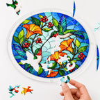 Hand assembling a hummingbird orange flower acrylic puzzle suncatcher