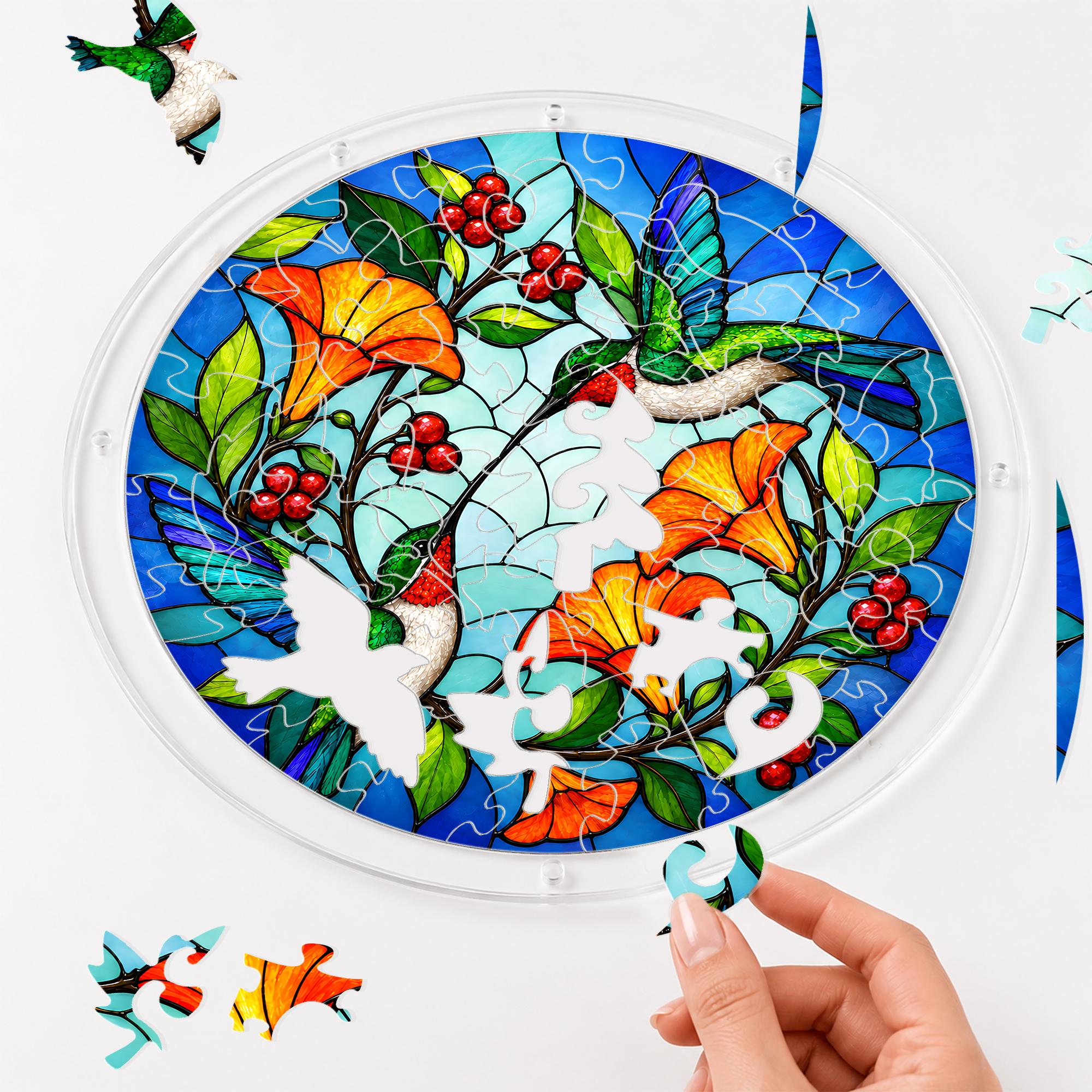Hand assembling a hummingbird orange flower acrylic puzzle suncatcher