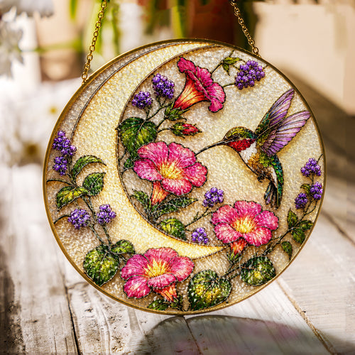 Hummingbird and pink flowers stained glass suncatcher with gold frame on a white background