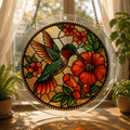 Hummingbird red hibiscus acrylic puzzle suncatcher hanging by a sunny window with clear acrylic frame and metal chain