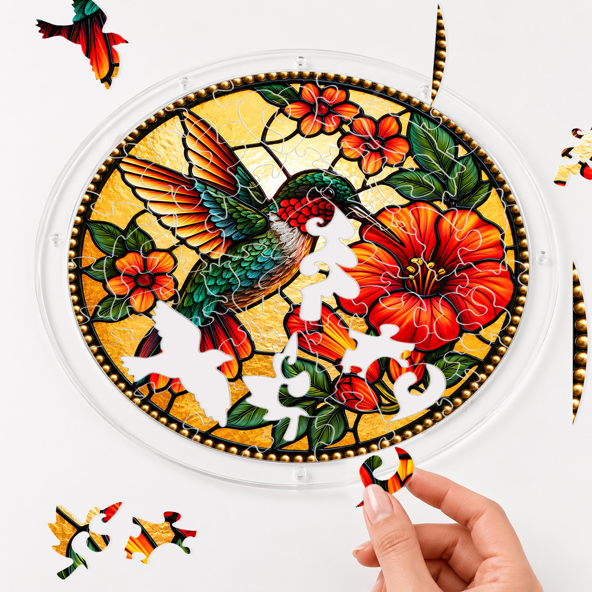 Hand assembling a hummingbird red hibiscus acrylic puzzle suncatcher with colorful puzzle pieces