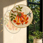 Hummingbird trumpet flower suncatcher with colorful light reflection