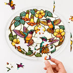 Hand assembling a hummingbird yellow flower acrylic puzzle suncatcher