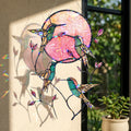 Hummingbird pink moon acrylic suncatcher hanging in sunlight by window