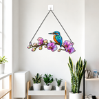 Kingfisher and orchid holographic acrylic suncatcher reflecting rainbow light across a room