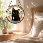 Decorative glass panel with a black cat named Luna, placed in a bedroom.
