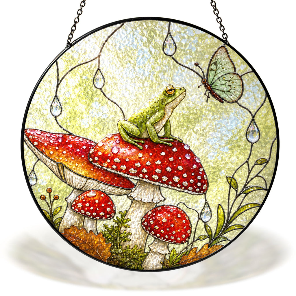 Frog on a red toadstool stained glass suncatcher hanging in a window