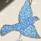 Personalized blue bird memorial crystal suncatcher in a window