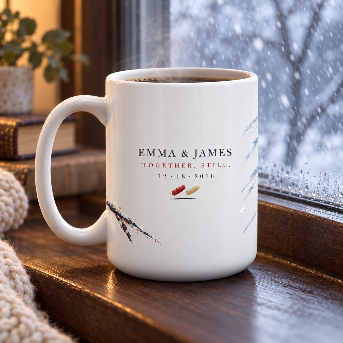 Personalized cardinal mug steaming on a windowsill with snow falling outside, names visible on the back