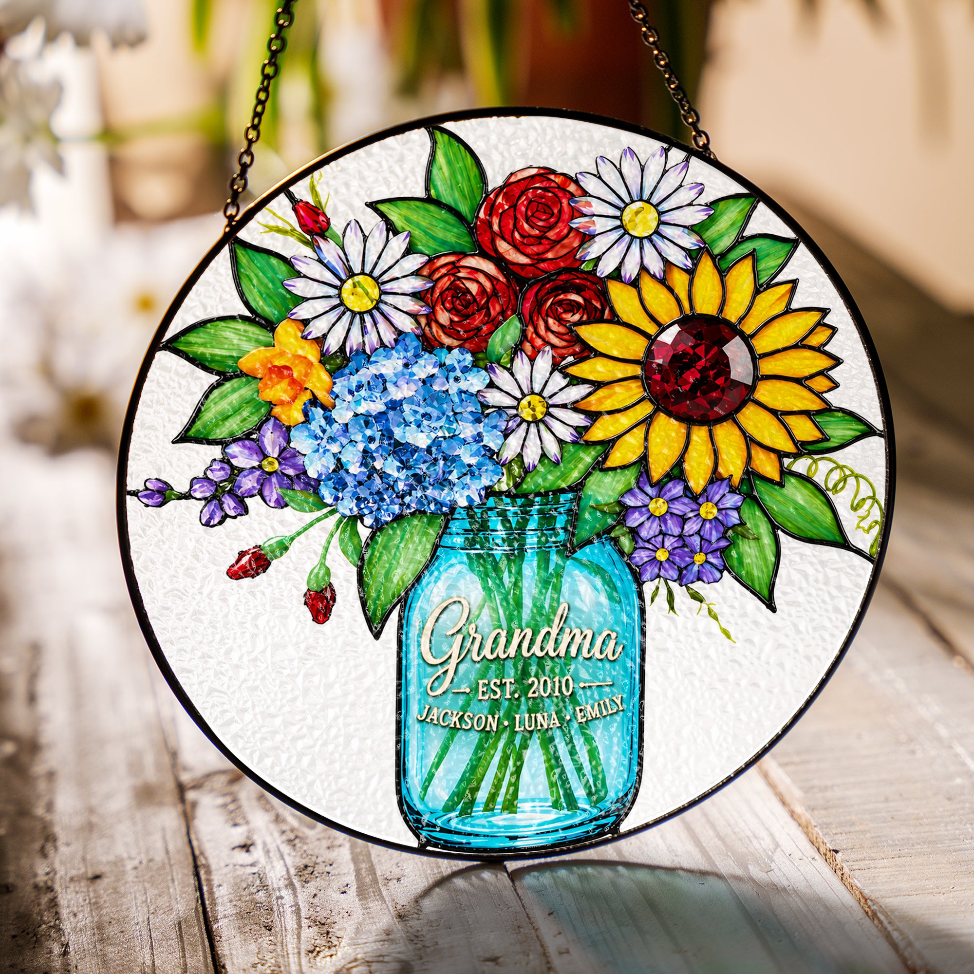 Personalized grandma suncatcher hanging in a sunny window