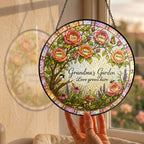 Hand holding the personalized Grandma's Garden rose tree suncatcher by a window