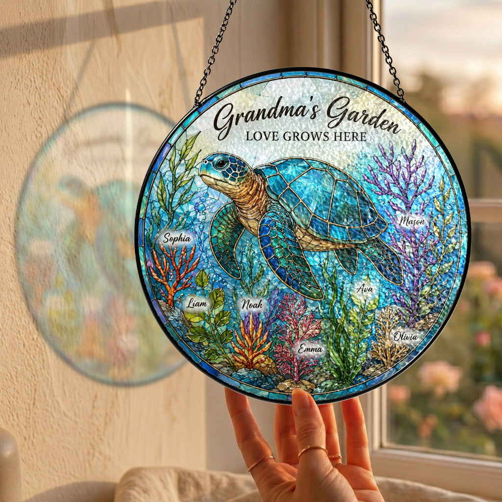 Hand holding the personalized Grandma's Garden sea turtle suncatcher by a window
