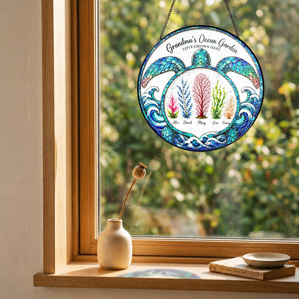 Turtle suncatcher with custom names hanging in a wooden window frame