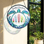 Grandma's Ocean Garden turtle suncatcher on a wall with rainbow sunlight
