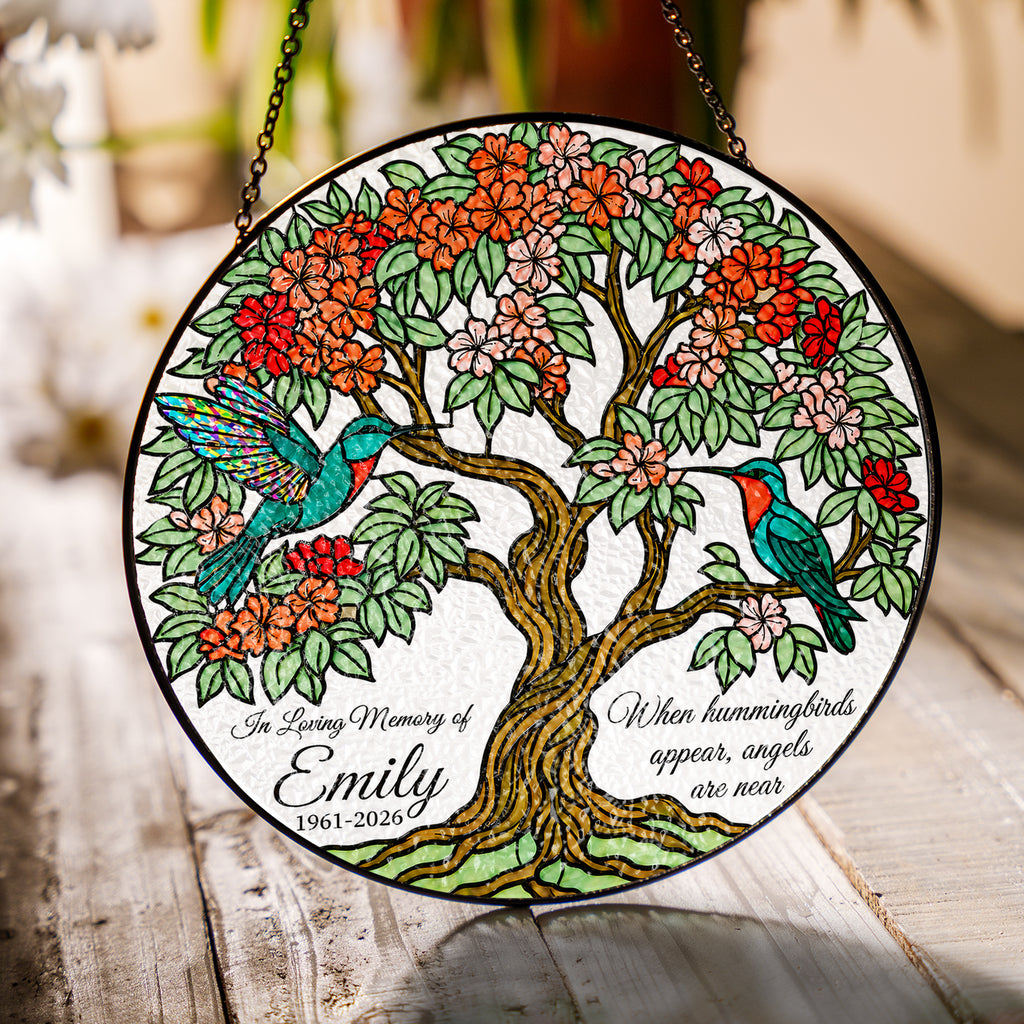 Hummingbird tree of life memorial suncatcher in a bright window with soft daylight