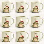 Nine frog pottery mugs with different initials — A, C, E, H, J, L, R, S and W — each with a watercolor frog in a red Santa hat