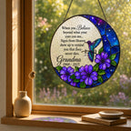 Purple floral hummingbird memorial suncatcher on a windowsill