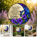 Purple floral hummingbird memorial suncatcher held in hand