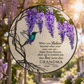 Memorial suncatcher near a sunlit window with wisteria and soft light