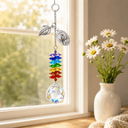 Personalized cardinal memorial crystal suncatcher hanging by a sunny window with silver leaf charm, custom oval cardinal charm, rainbow crystals, and clear crystal ball