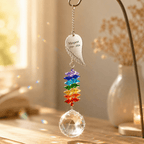 Personalized memorial angel wing crystal suncatcher hanging by a sunny window with custom Margaret wing charm, rainbow crystals, and clear crystal ball