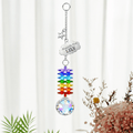 Personalized memorial cloud star crystal suncatcher hanging in front of soft white curtains with custom Lily cloud charm, silver star charm, rainbow crystals, and clear crystal ball
