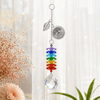 Personalized Tree of Life memorial crystal suncatcher hanging by a sunny window with leaf charm, custom round charm, rainbow crystals, and clear crystal ball