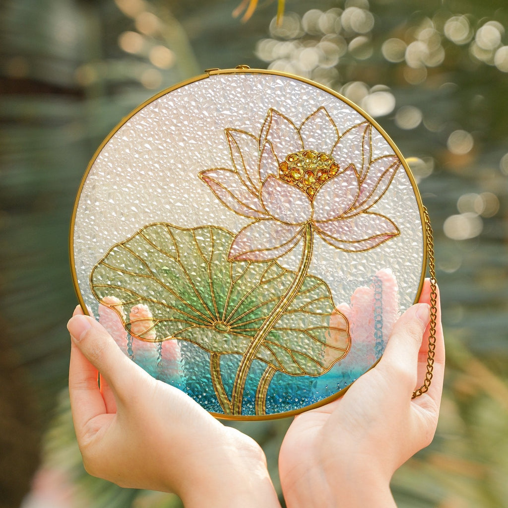 Pink lotus blossom stained glass suncatcher held in hand